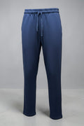 Blue track pants with pockets and a drawstring on a white background