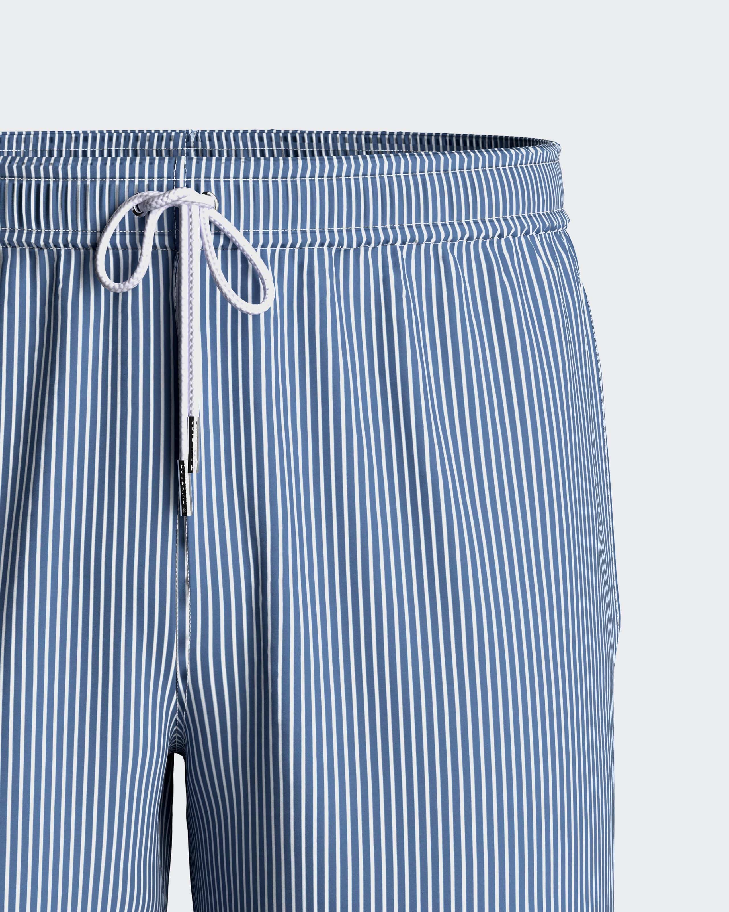 Maison Sarava blue and white striped men's swim shorts with drawstring and pockets.