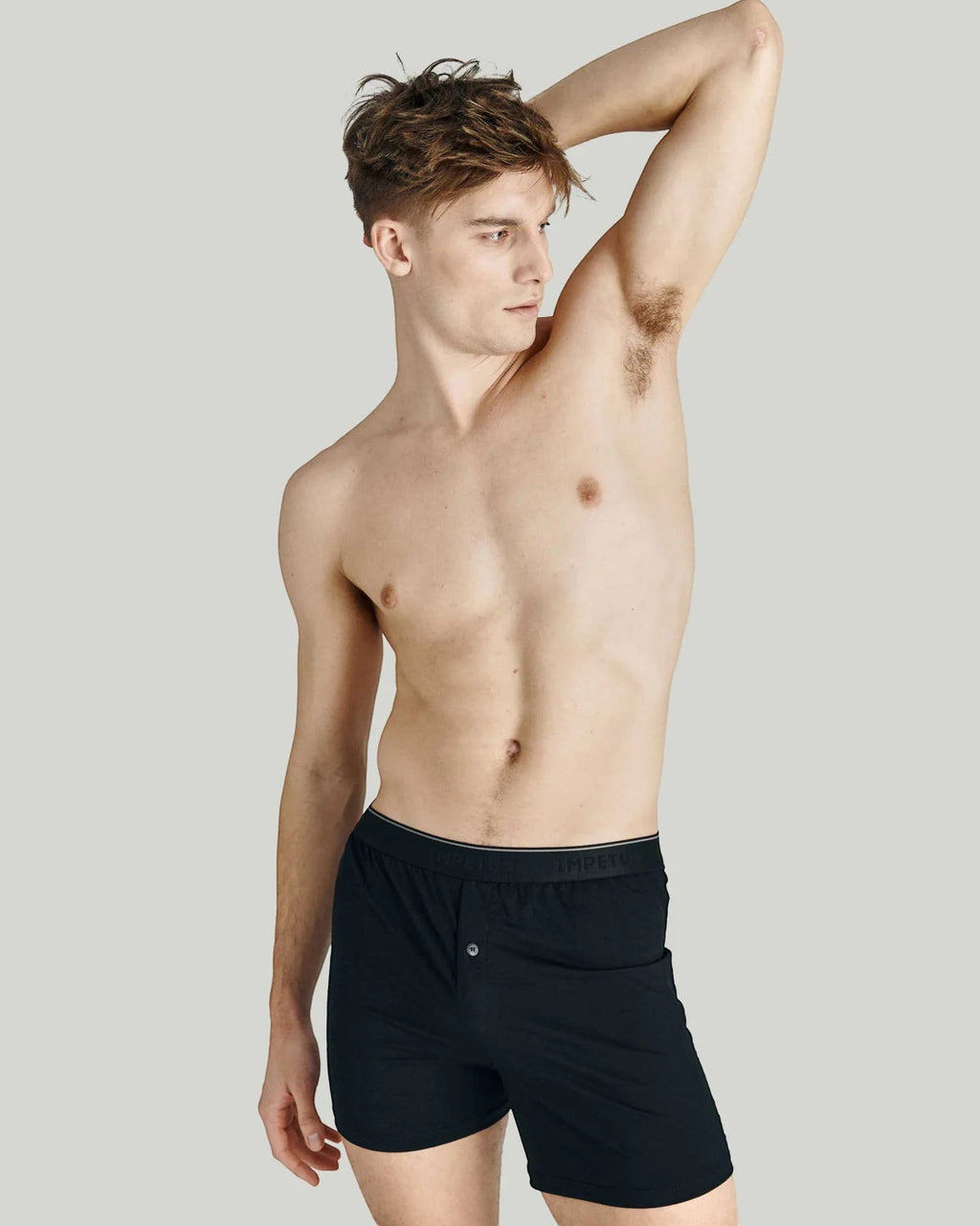 Maison Sarava black cotton boxer briefs with button fly and elastic waistband on male model.