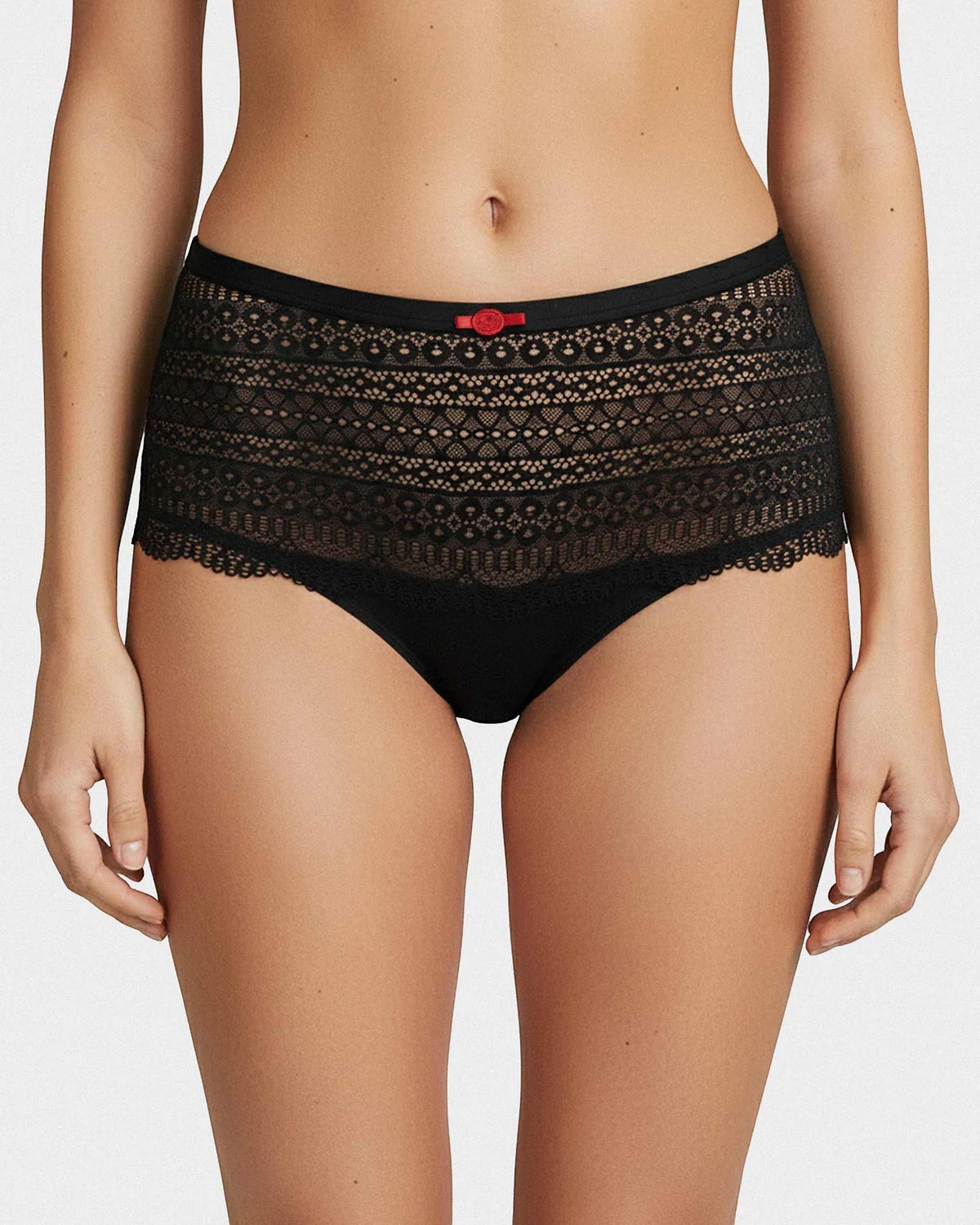 Maison Sarava black hipster brief underwear with intricate lace detailing and a small red bow accent.