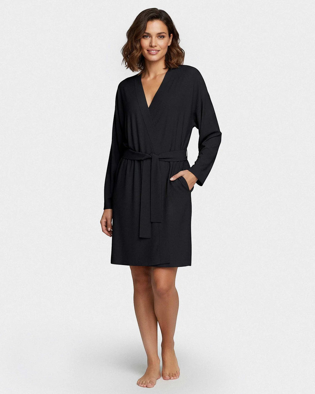 Maison Sarava black TENCEL™ Lyocell kimono robe with adjustable belt and pockets, worn by a woman.
