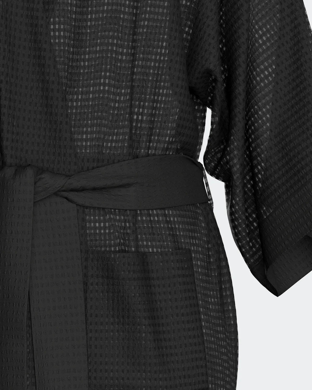 Maison Sarava black waffle knit kimono robe with wide sleeves and self-tie belt, featuring two side pockets.