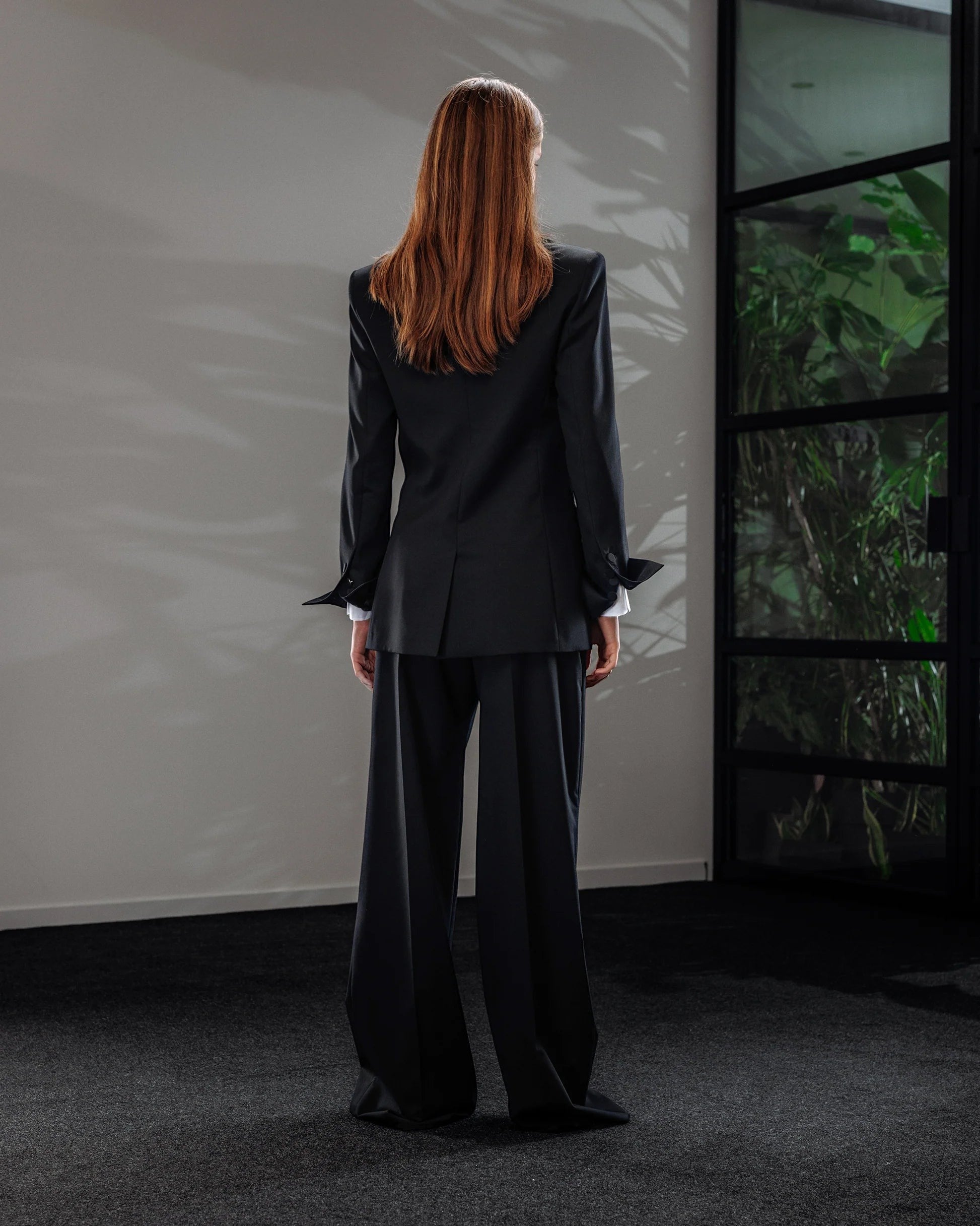 Maison Sarava women's black wool double-breasted blazer with peak lapels and fitted cut.