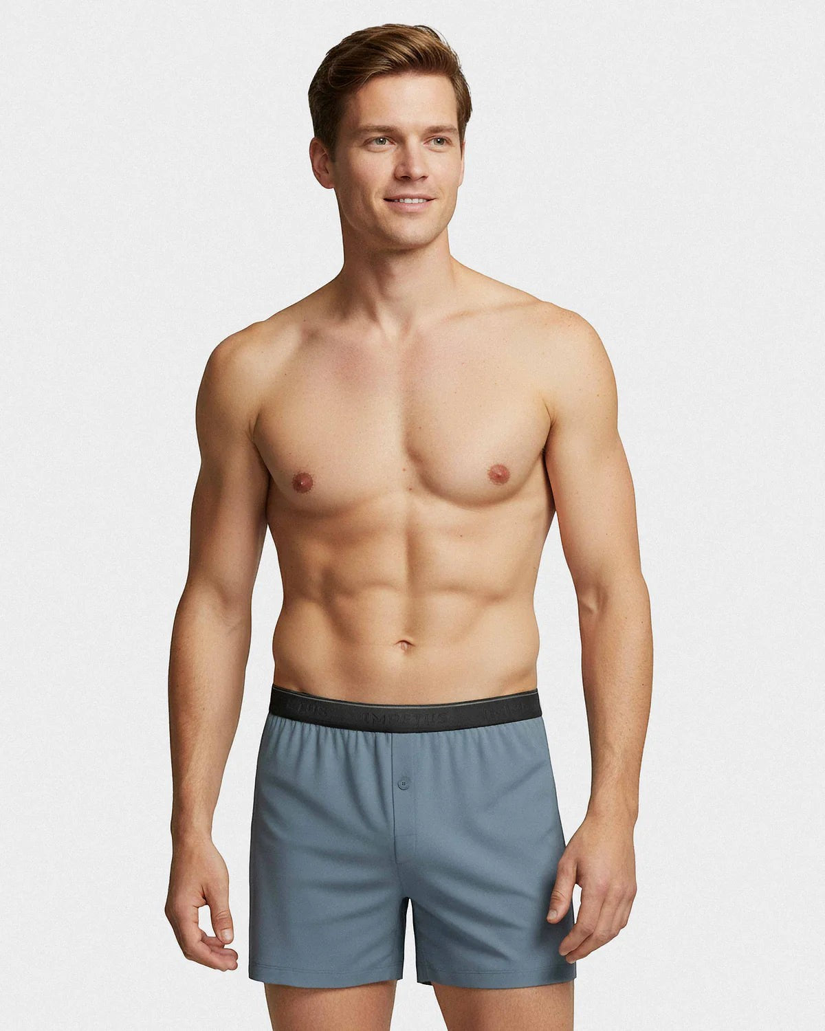 Maison Sarava blue boxer briefs with black waistband and button fly, worn by a man against a white background.