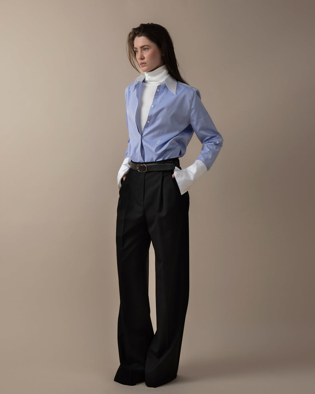 Maison Sarava women's blue fitted shirt with white contrast collar and cuffs, hidden buttons, and back pleat detail.