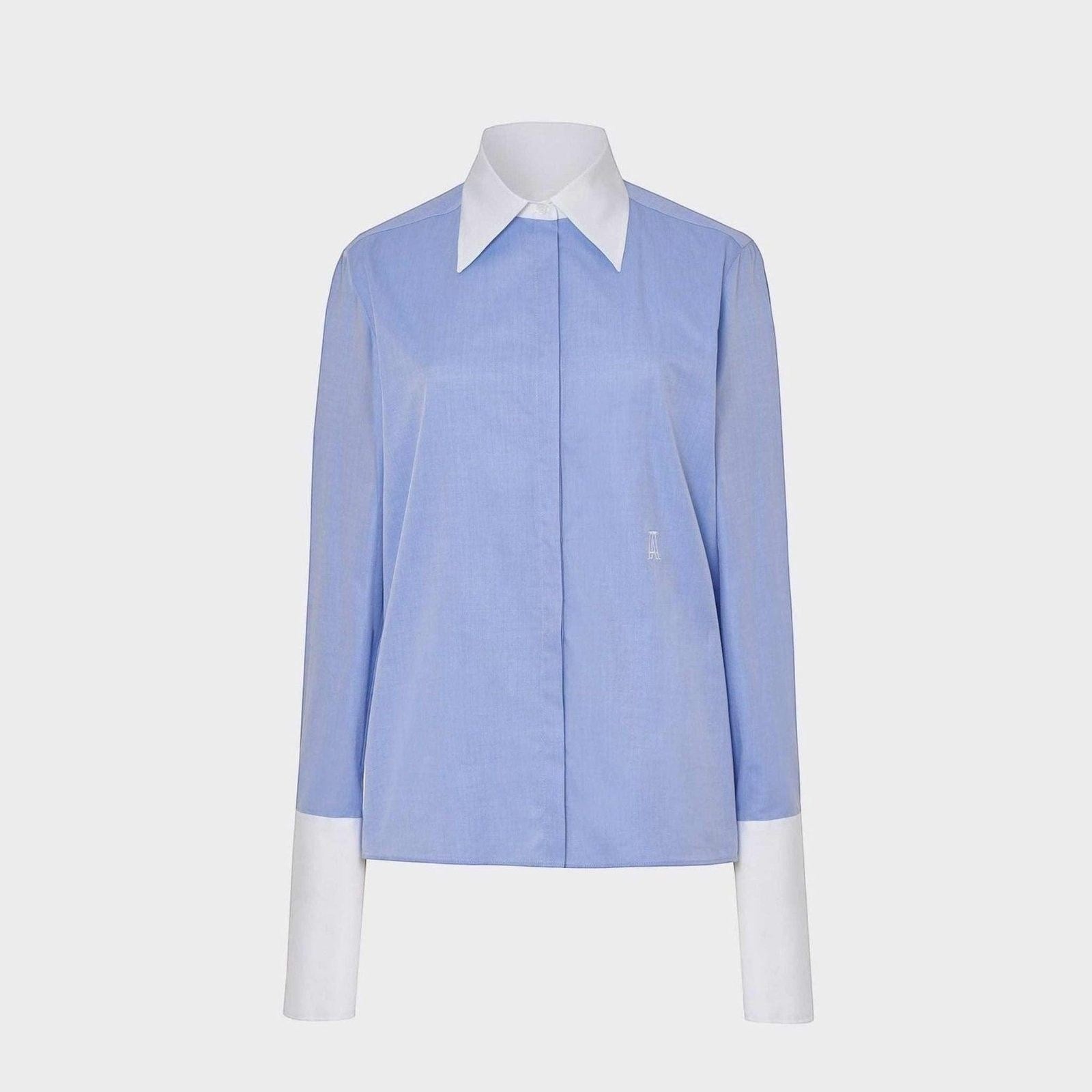 Maison Sarava women's fitted blue cotton shirt with white contrast pointed collar and cuffs, hidden buttons, and subtle embroidered logo.
