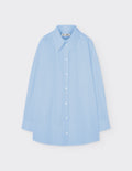 Maison Sarava light blue oversized cotton shirt with pointed collar, dropped shoulders, and double-pleat cuffs.