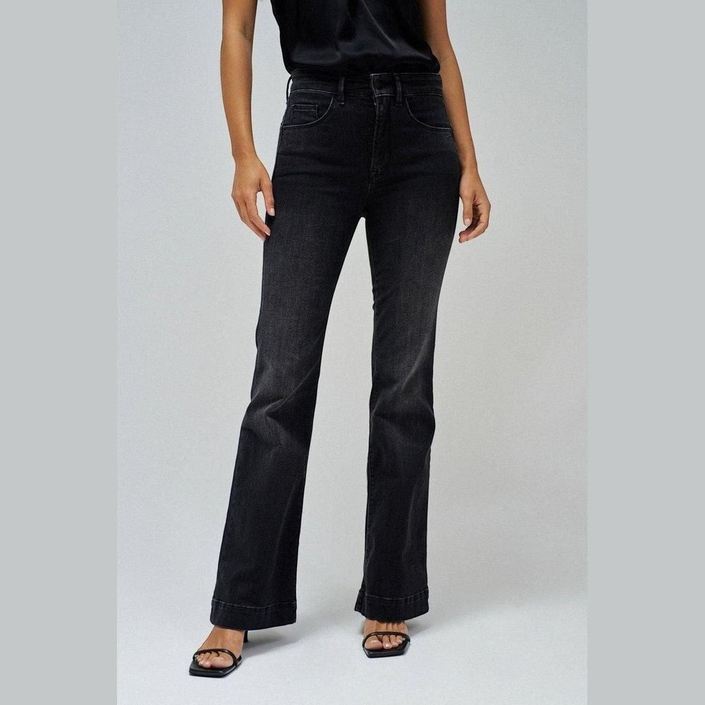 Maison Sarava charcoal wash high waisted flare denim jeans on a model.