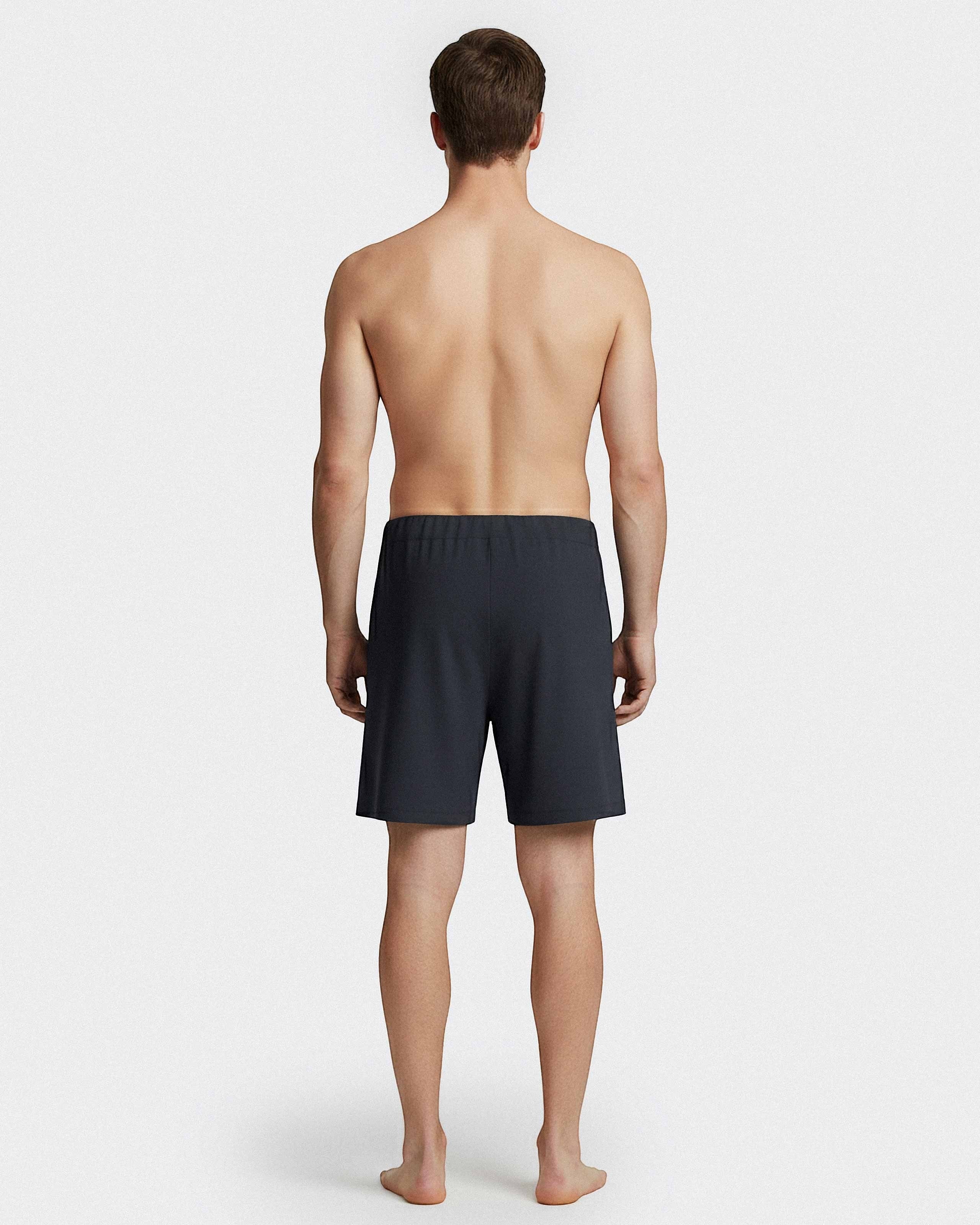 Maison Sarava dark grey cotton lounge shorts with elastic waistband and drawstring, worn by a man from behind.