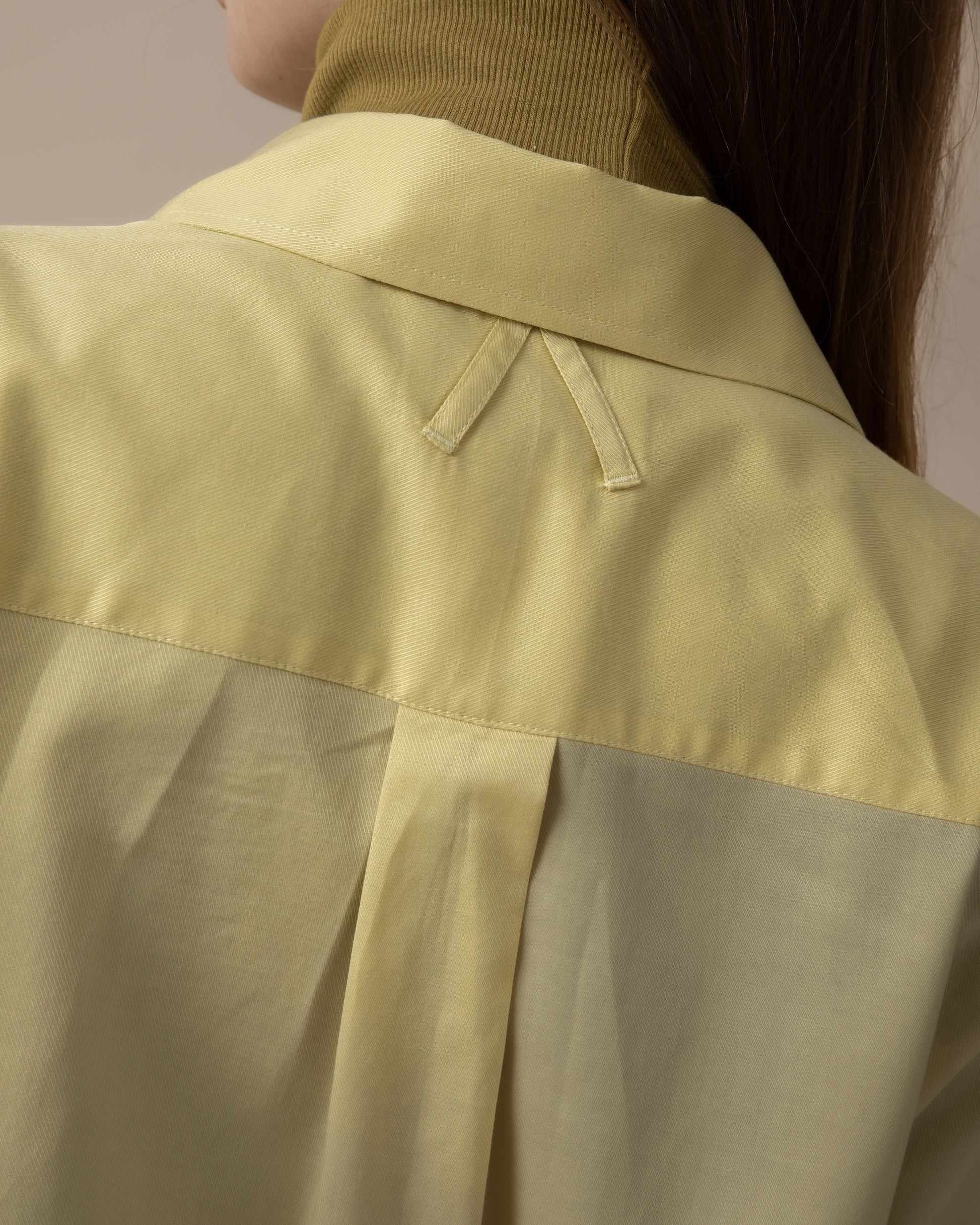 Maison Sarava women's fitted shirt in pale yellow with a pointed collar and back yoke detail.