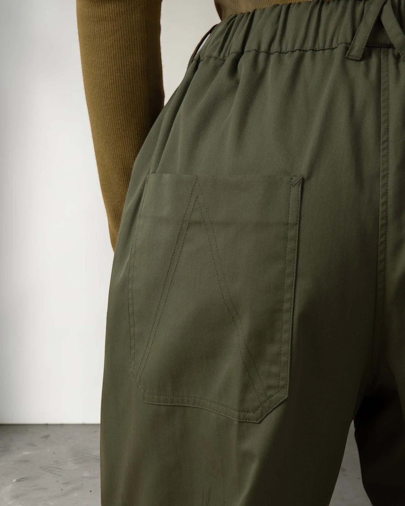 Maison Sarava olive green cotton drawstring straight leg pants with cargo pockets and high-rise fit.