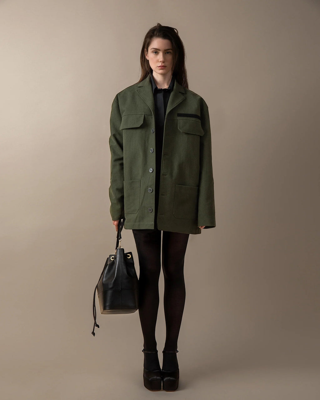 Maison Sarava green oversized utility jacket with peaked lapels, patch pockets, and elbow patches. Unisex design.