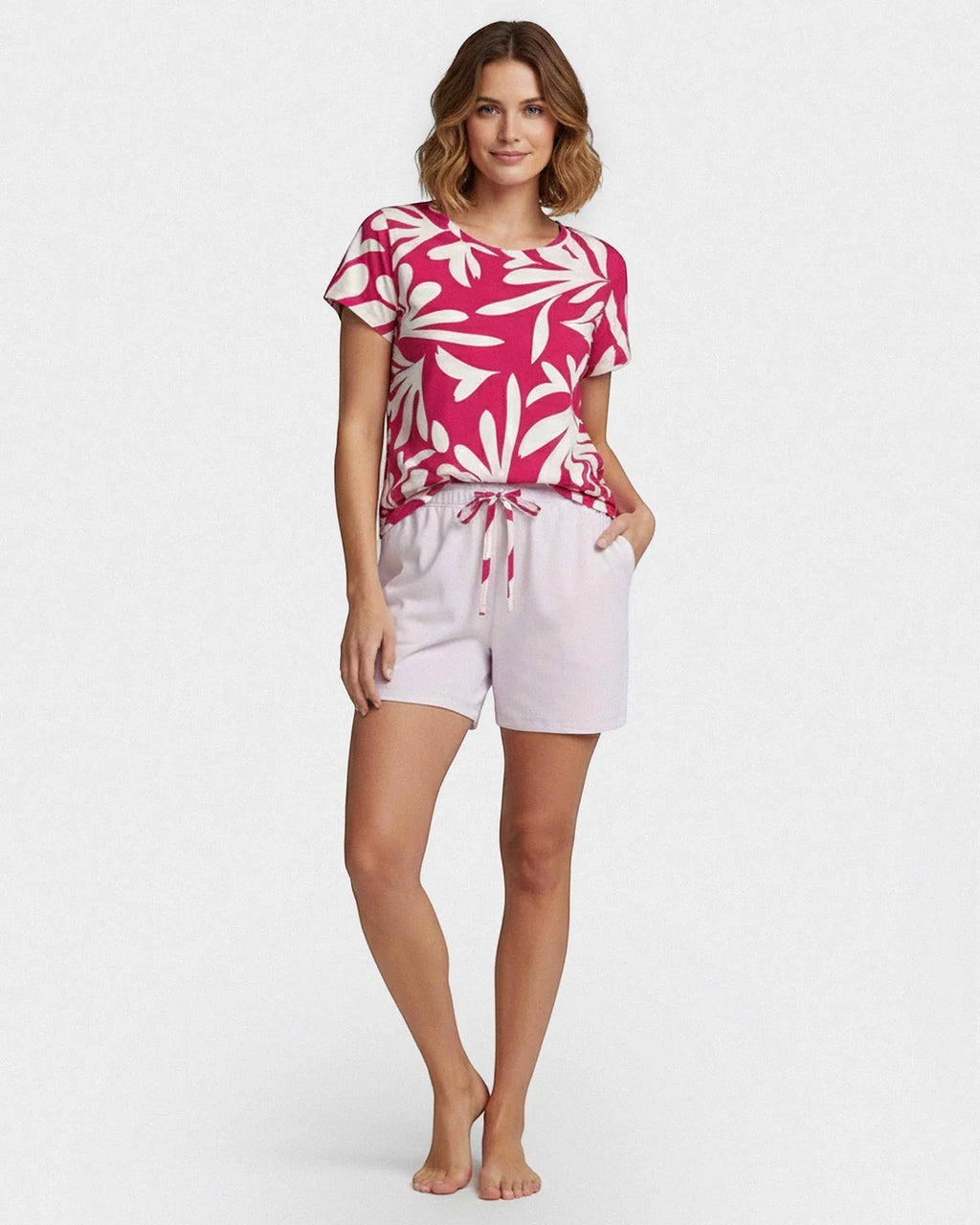Maison Sarava women's pink and white floral print lyocell short sleeve lounge set with light purple drawstring shorts.
