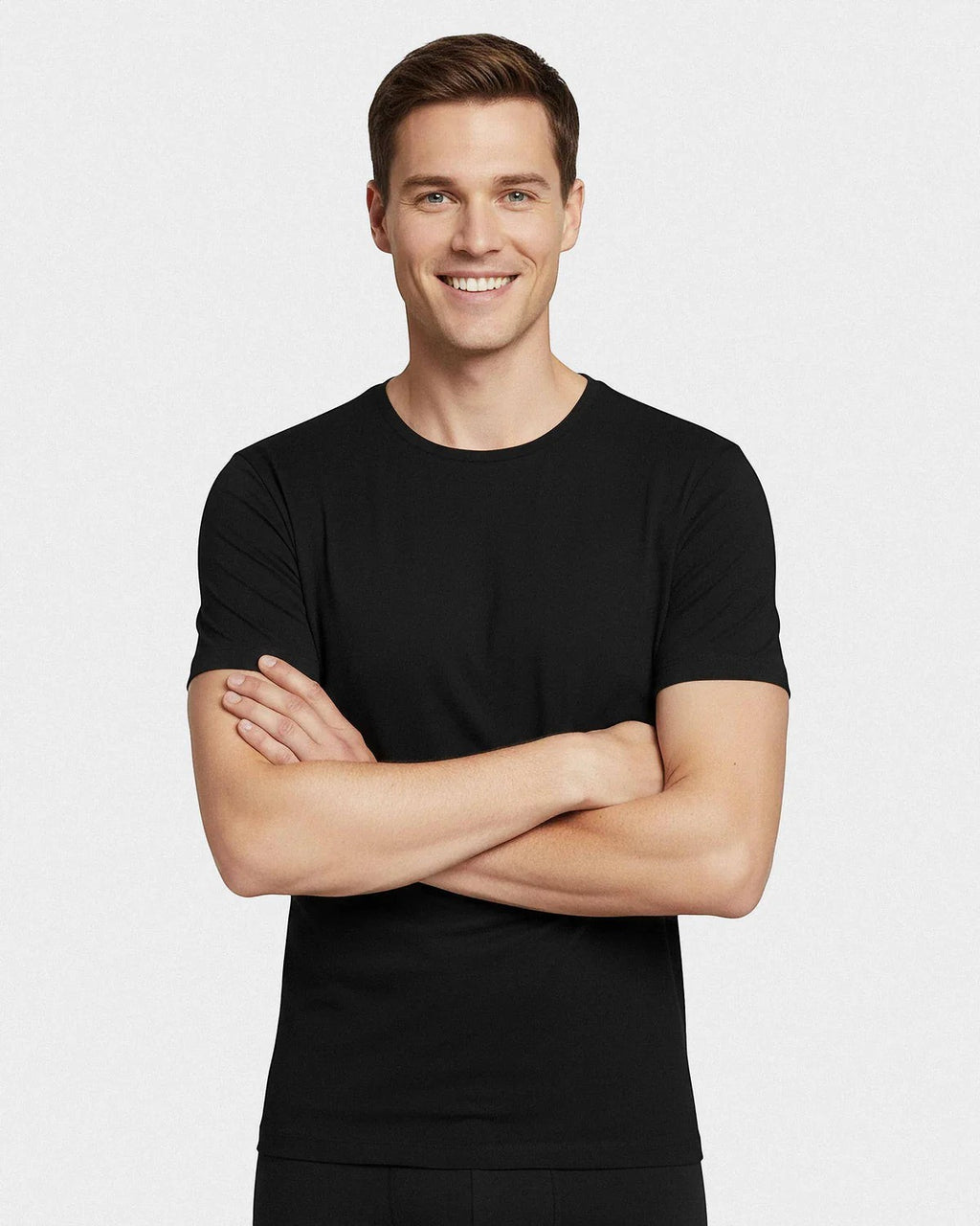 Maison Sarava men's black short-sleeved Merino wool t-shirt with a round neck. Model with arms crossed.
