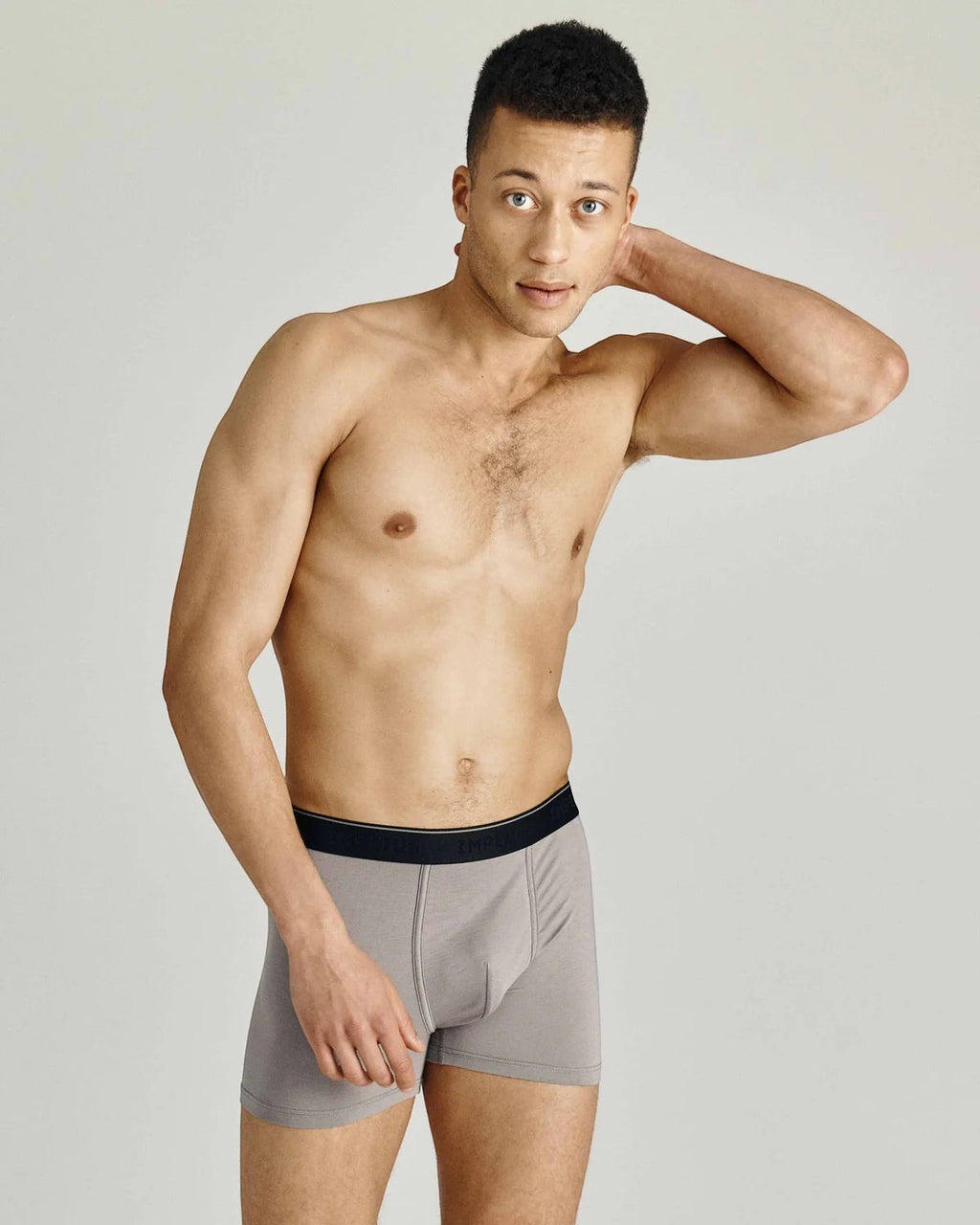 Maison Sarava men's grey cotton blend boxer briefs with black elastic waistband. Model posing against a light grey background.