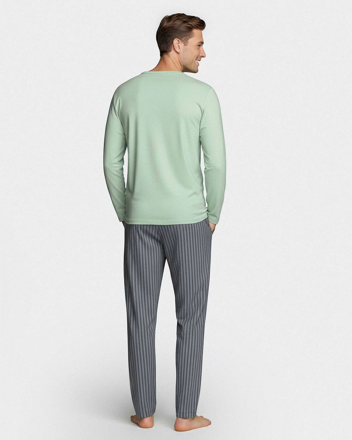 Maison Sarava men's light green long sleeve V-neck top with subtle chest embroidery and grey striped lounge pants made from cotton and TENCEL Modal.
