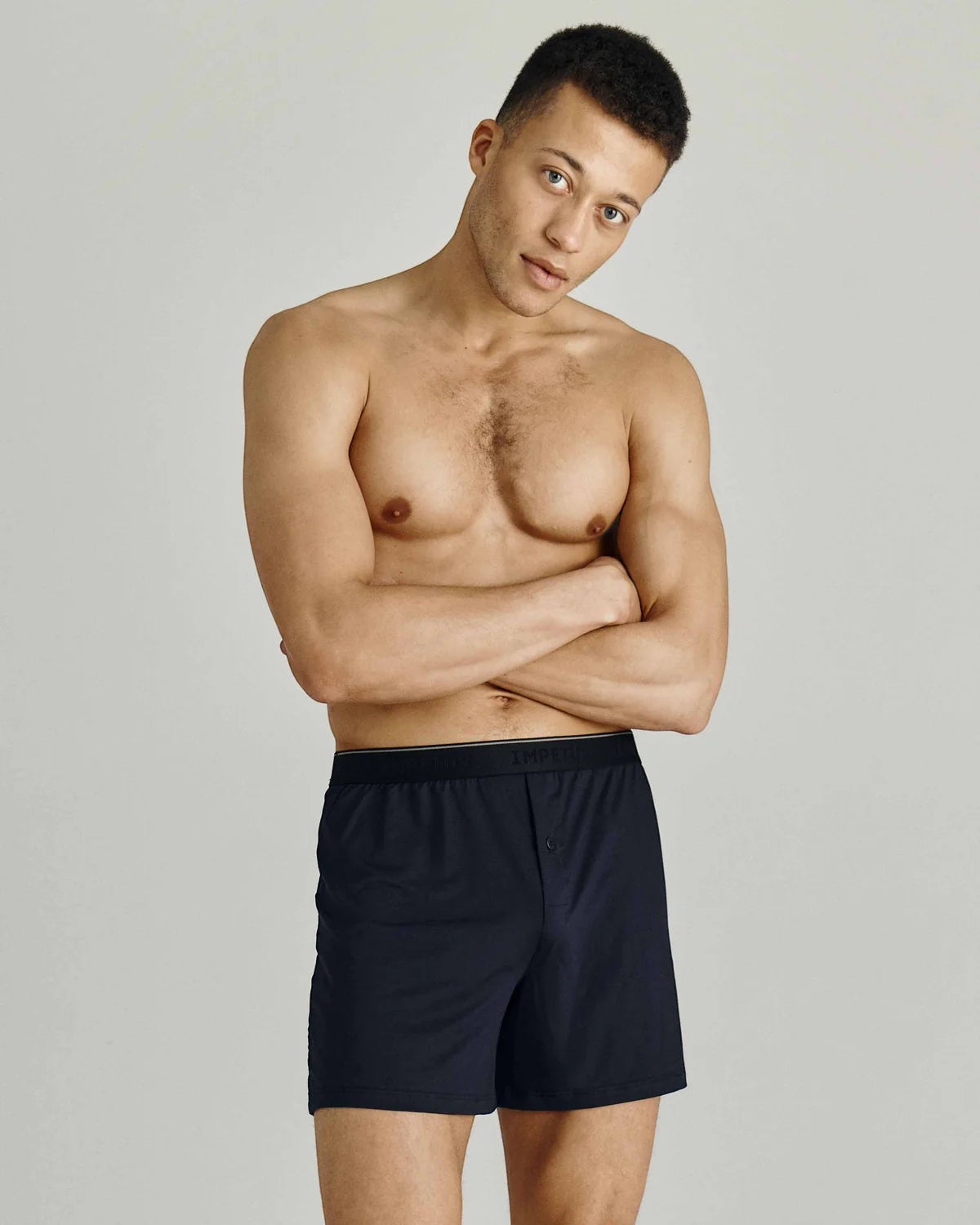 Maison Sarava navy blue classic boxer briefs with button fly and elastic waistband on a male model.