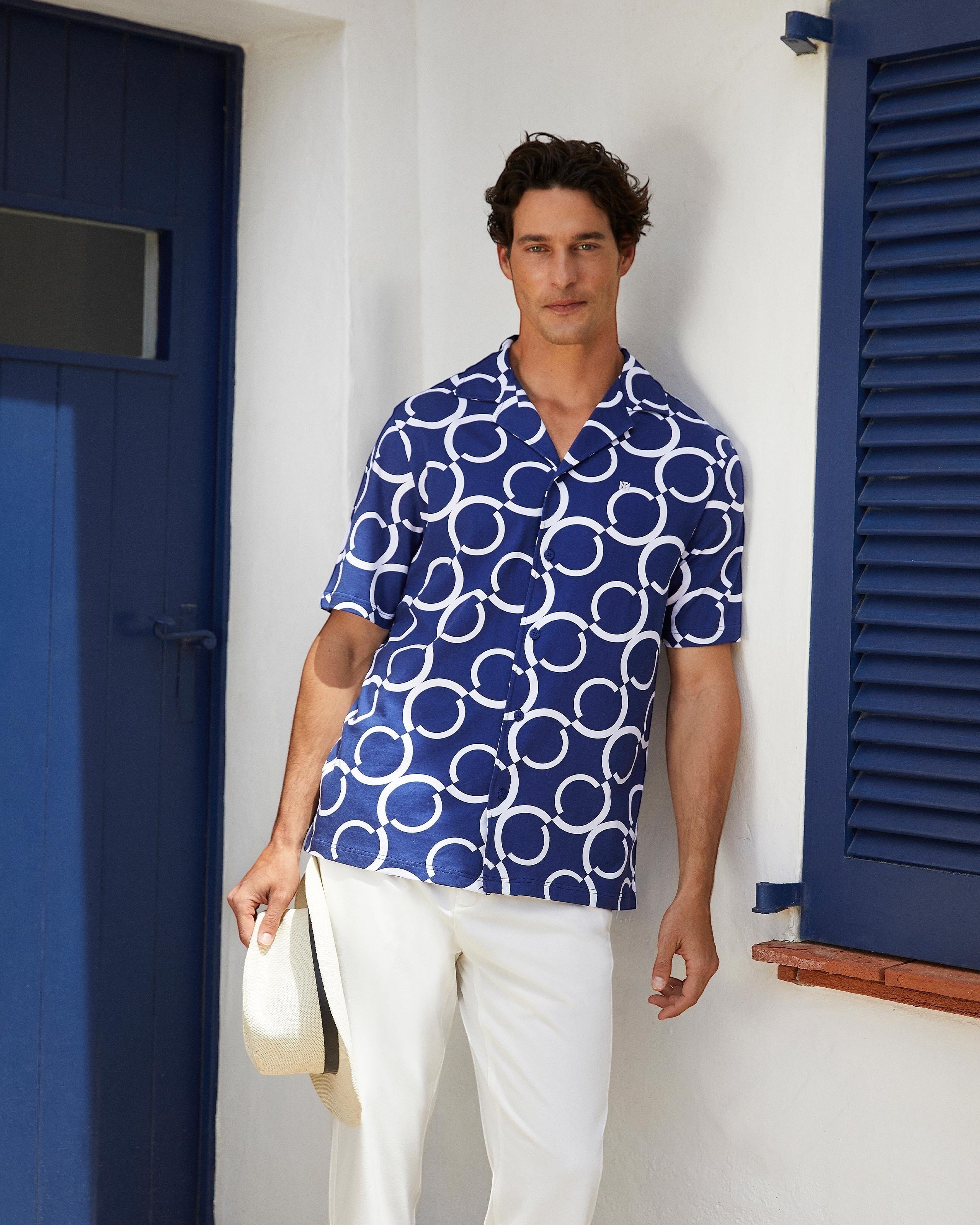 Maison Sarava navy and white geometric print short sleeve resort shirt with open collar.