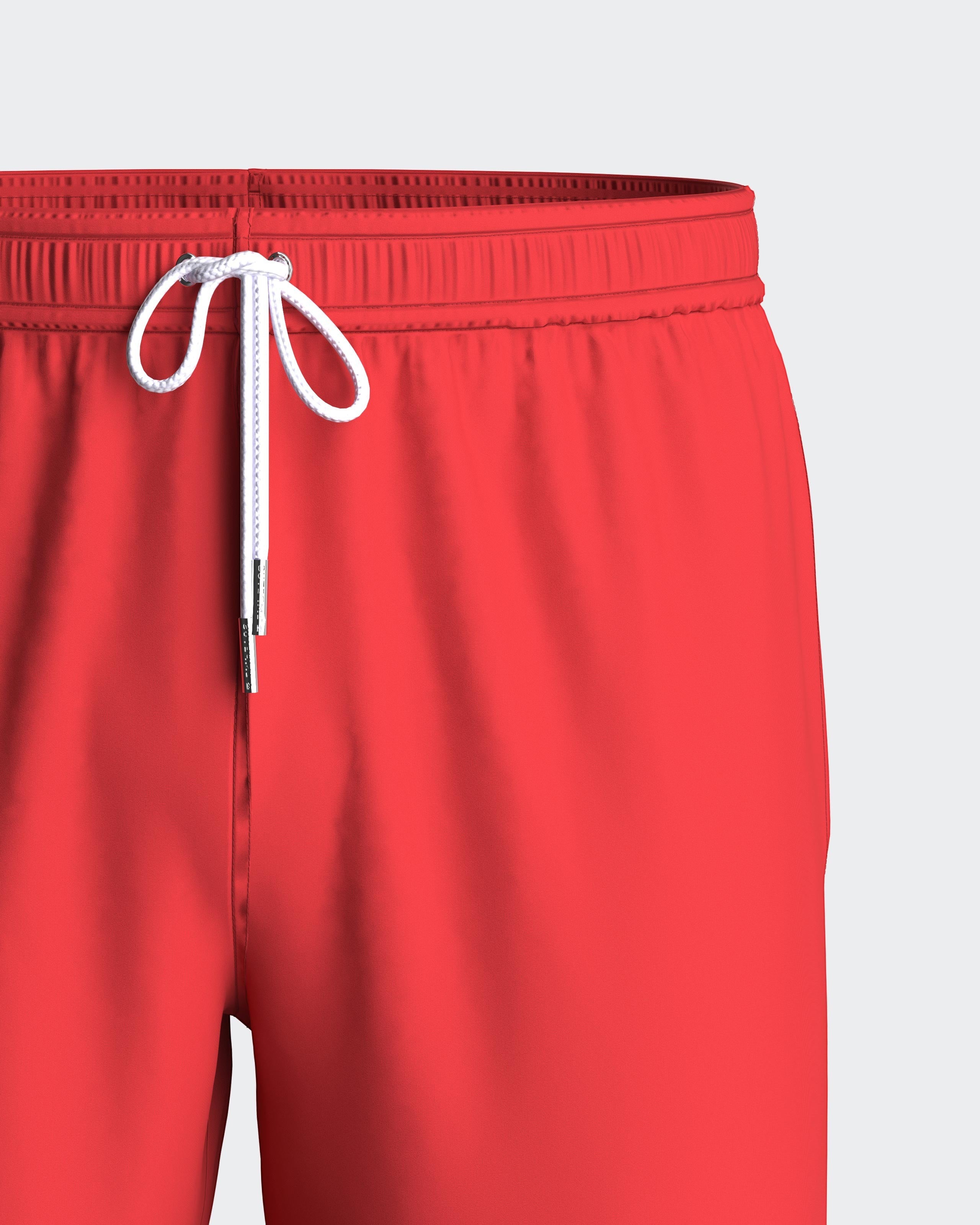 Maison Sarava red polyester men's swim shorts with adjustable drawstring waist and inner mesh lining.