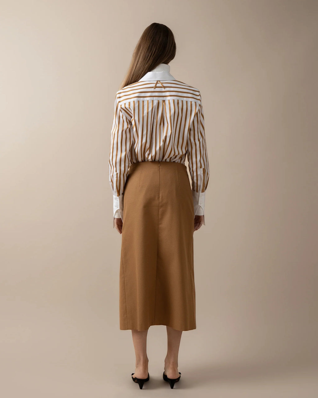 Maison Sarava women's fitted white shirt with brown vertical stripes, pointed collar, and A-design detail on back yoke.