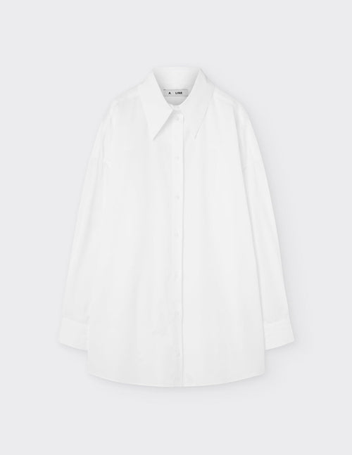 Maison Sarava white cotton oversized shirt with pointed collar, dropped shoulders, and double-pleat cuffs.
