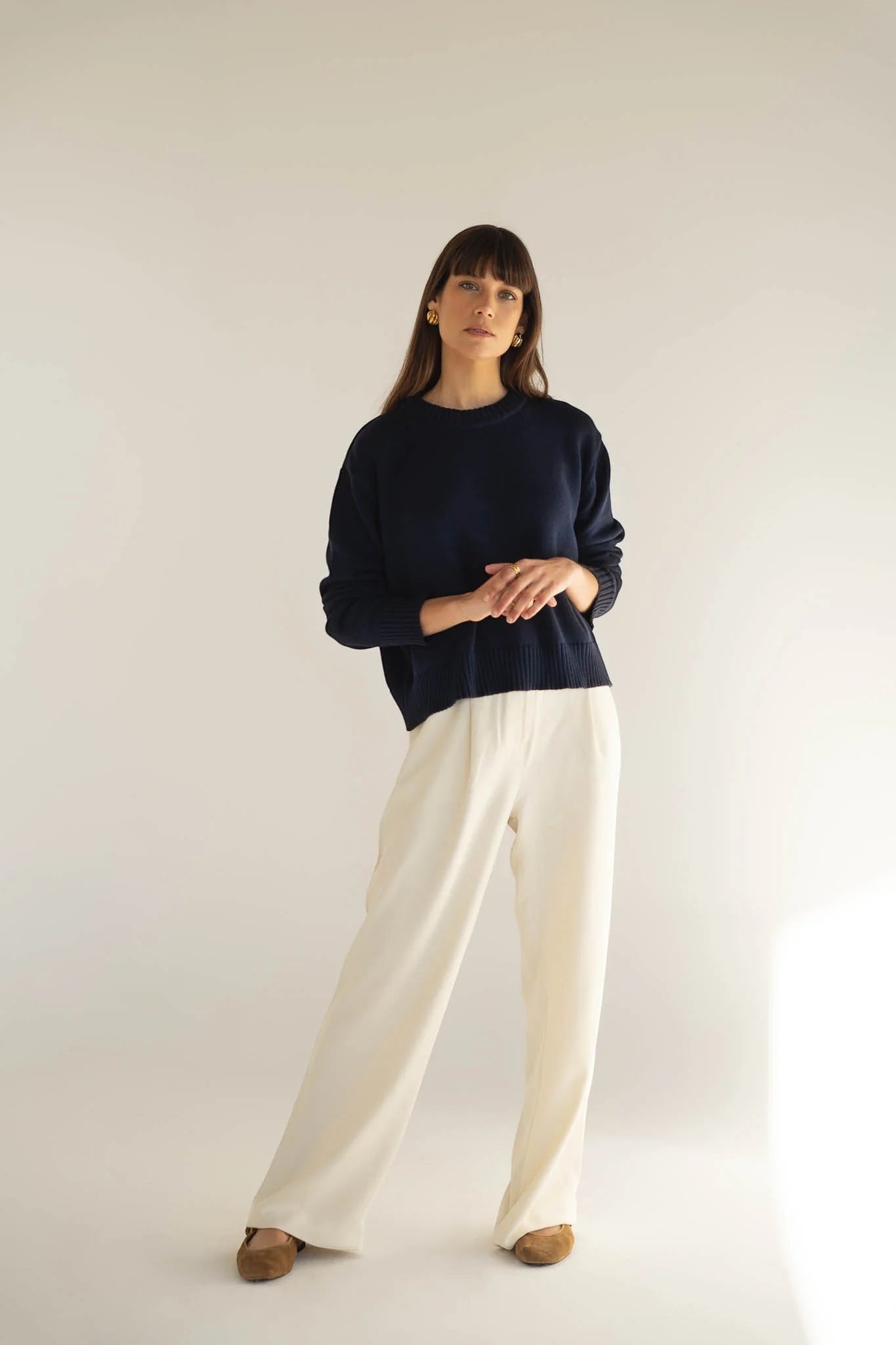 Maison Sarava white Tencel trousers with wide legs and elastic waistband on back, worn by a model.