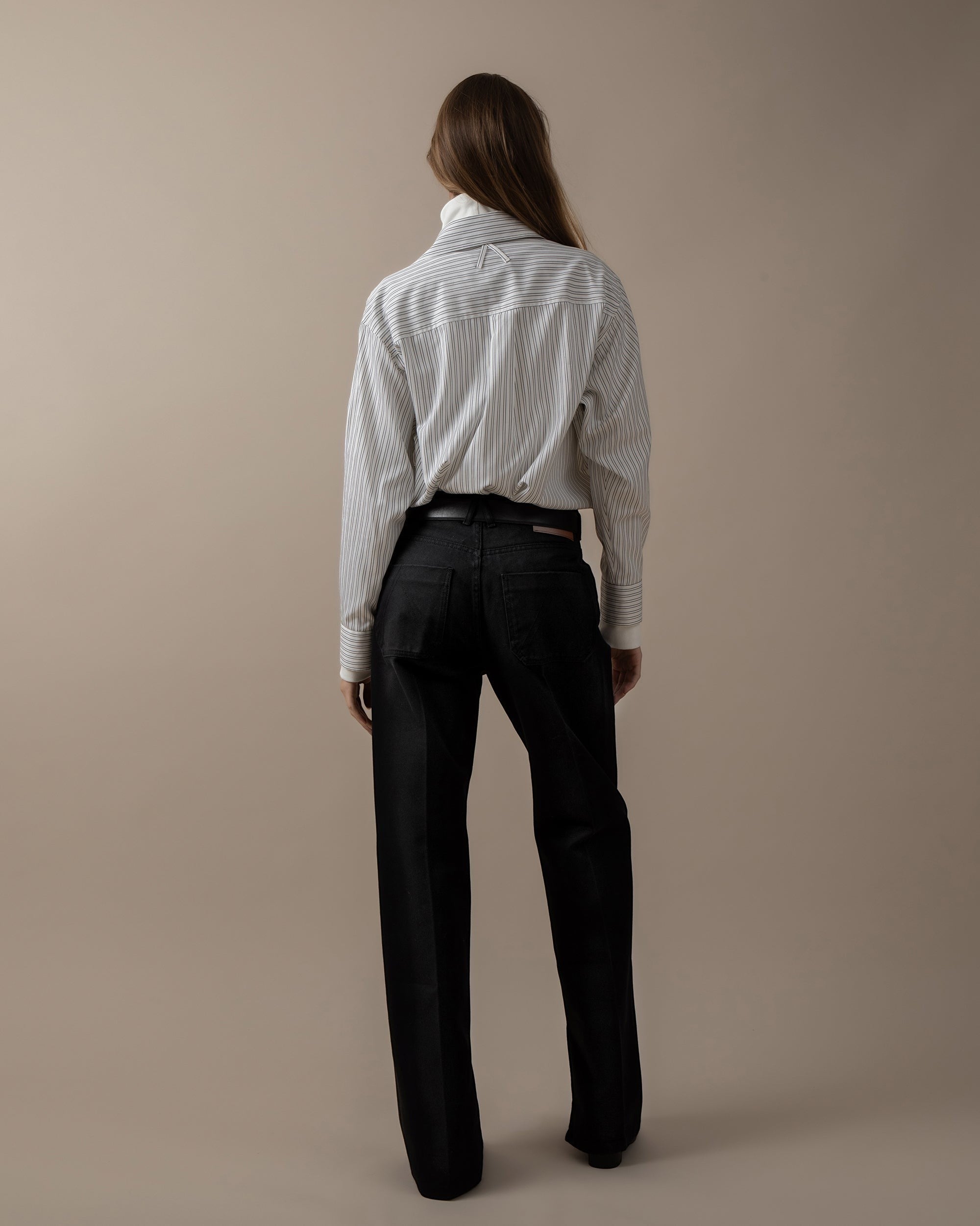 Maison Sarava women's oversized white and black pinstripe shirt with pointed collar and button cuffs.