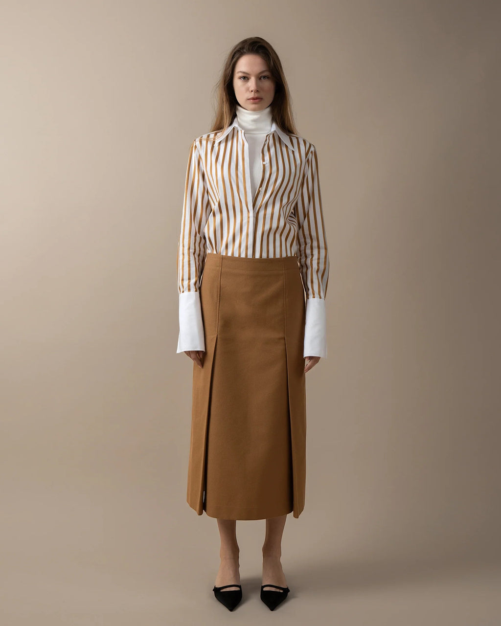 Maison Sarava women's fitted white shirt with brown vertical stripes, pointed collar, and high cuffs.